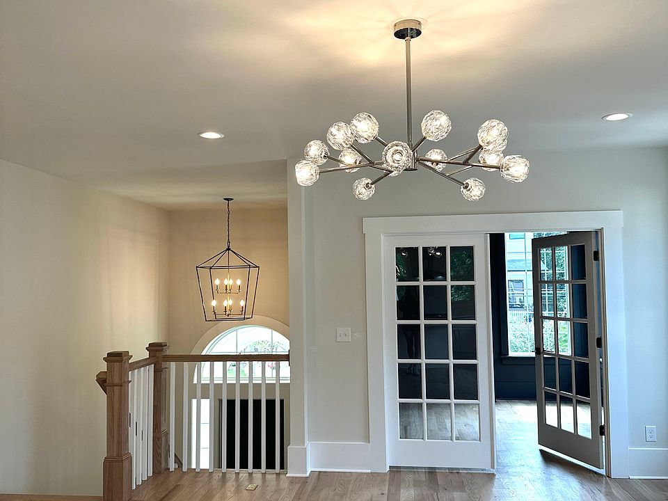On the second floor you have a very spacious living room with an extra room that is behind those French doors that can be used as an office/ flex room or dining room. These pictures are from a neighboring duet - light fixture is going to be a fan.