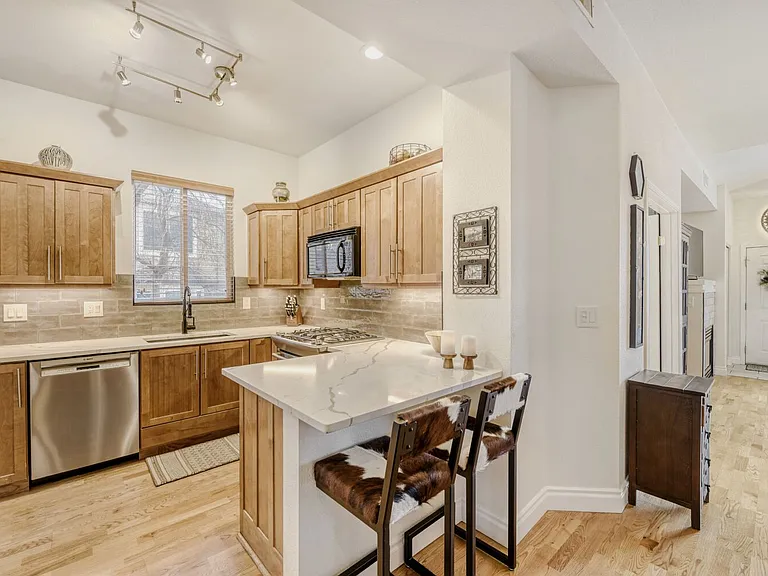Roomy updated kitchen with GAS COOKING. Breakfast bar seats two