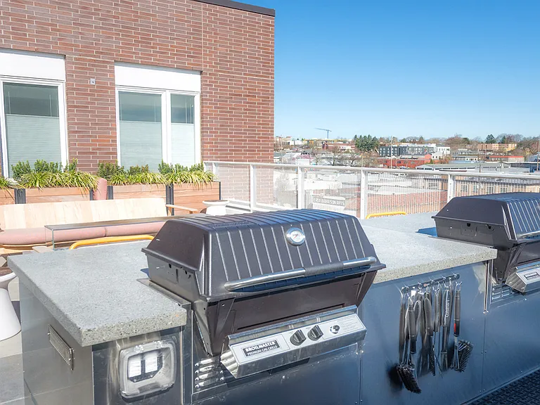 Rooftop grilling station with premium barbecue setup.