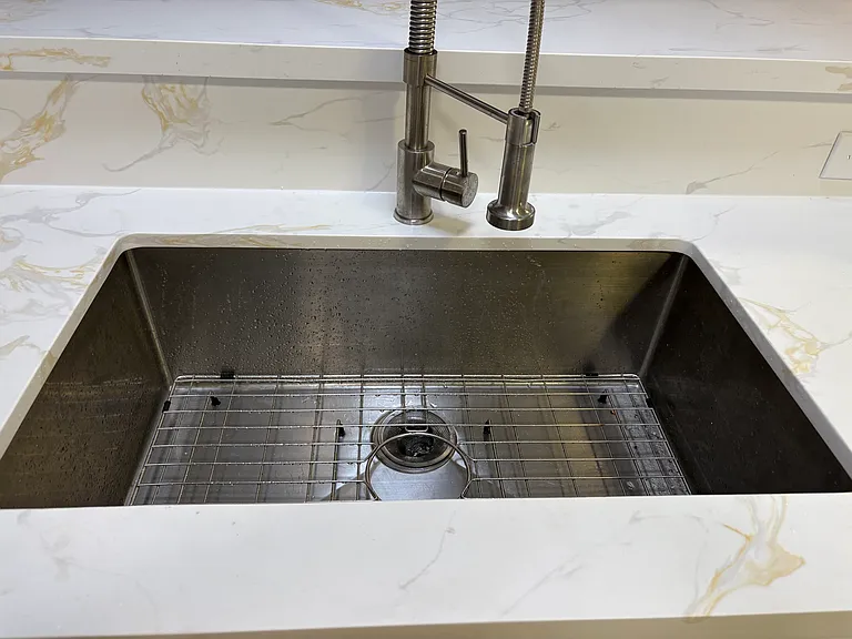 Brand new Quartz Counter Tops in Kitchen with under mount stainless steel sink/rack and expensive 
faucet
