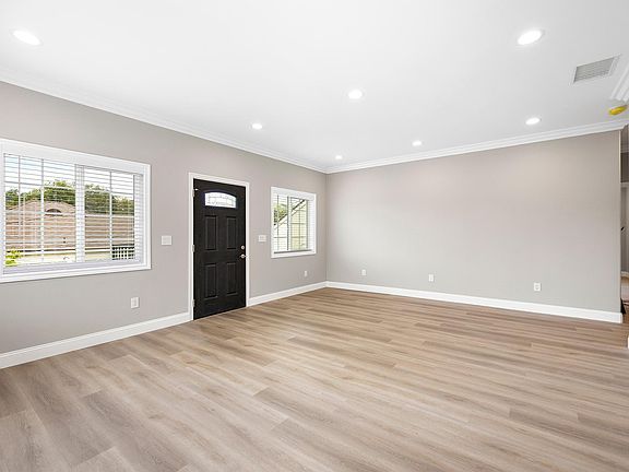 The view from the dining area to the living room. Beautiful flooring throughout.