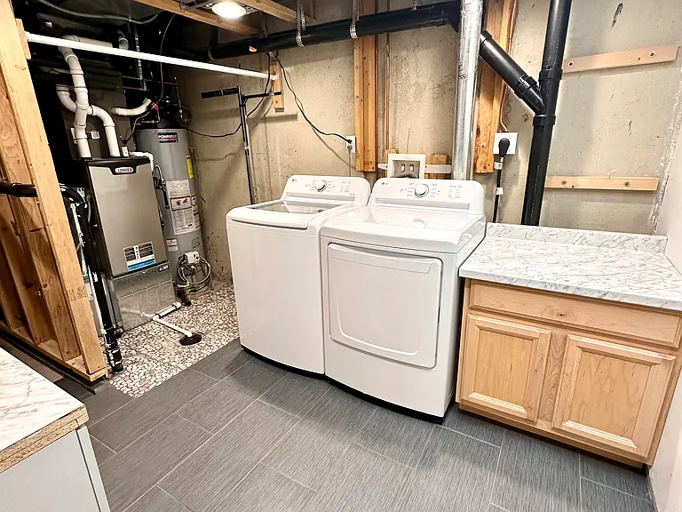 Basement laundry room with storage.