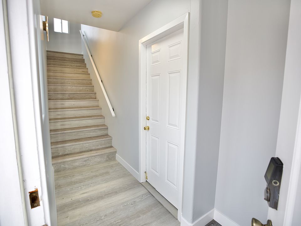 front door entry from the ground floor with door to garage