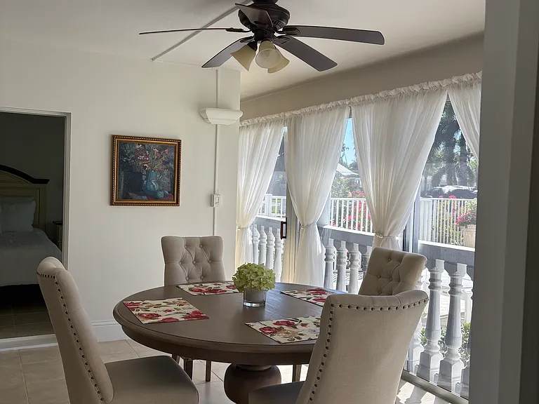 Dining area on patio off of pool area. Secured screened in sliders separate the property from the pool area