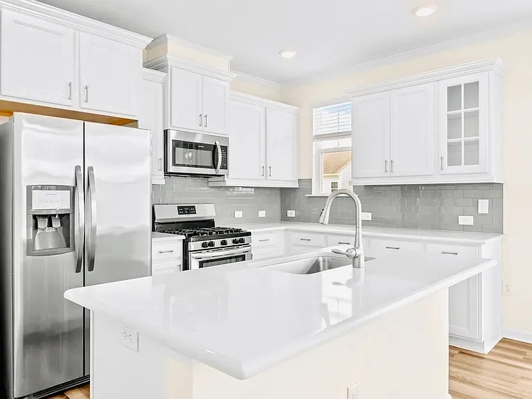 Granite counters, glass tile backsplash and all stainless steel appliances, walk-in pantry, sliding doors take you to deck out back with lots of windows and a sunset view.