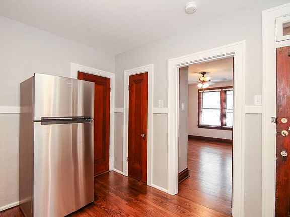 Kitchen looking into bedroom and rear door