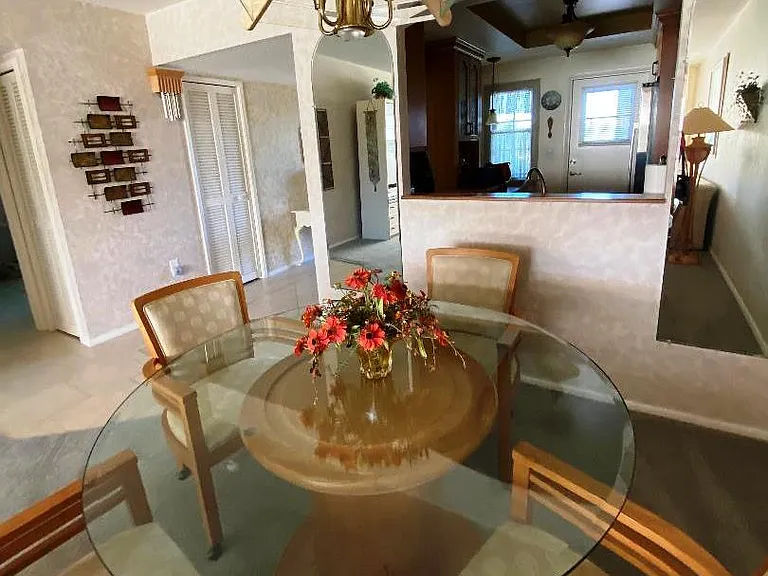 View through large pass-through from dining room to kitchen to exterior door.