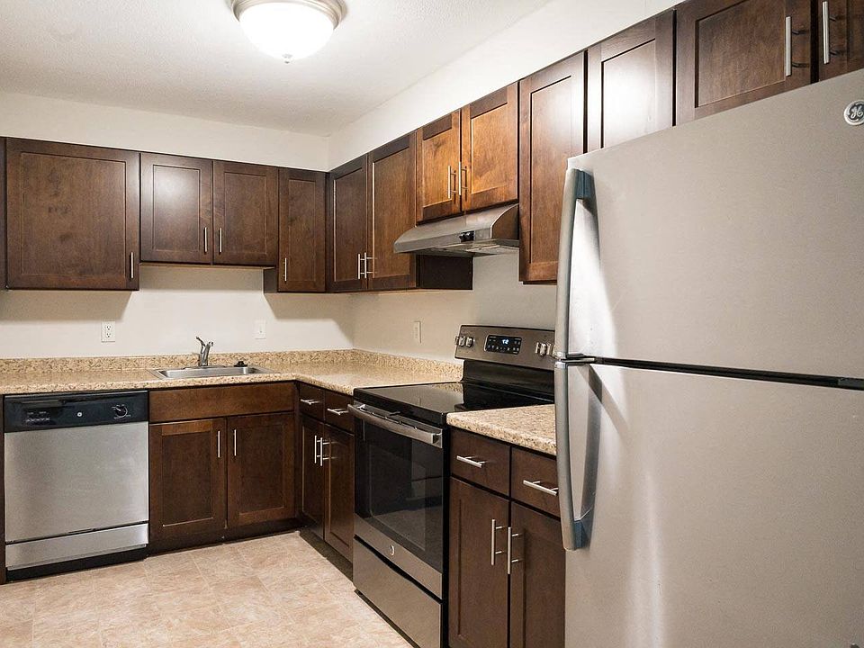 Classic kitchen style with rich cabinetry and neutral countertops, offering a warm, timeless aesthetic.