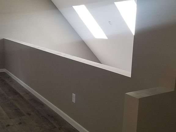 standing at the top of the steps looking towards the loft space and awesome daylight coming in