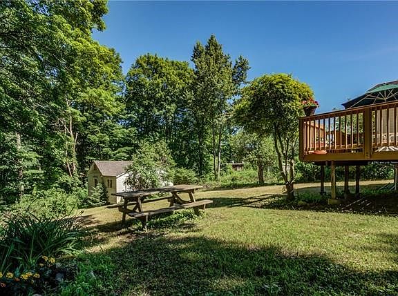 View of deck and additional dwelling in backyard.  Nature abounds!