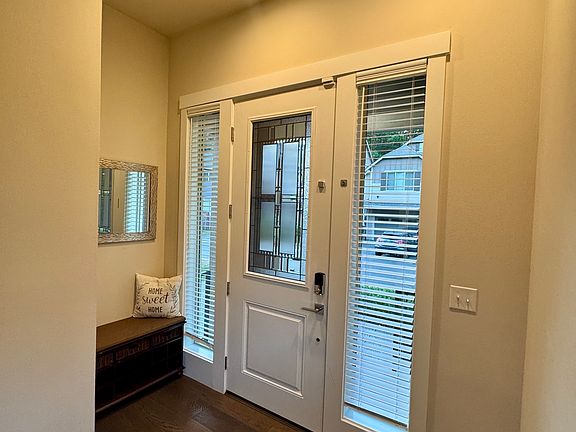 Entry way with custom ottoman (to be kept with rental property for use).