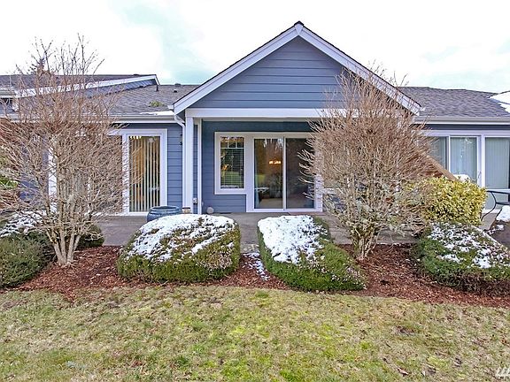 View to golf course with covered patio and access from the living room and master bedroom sliding glass doors