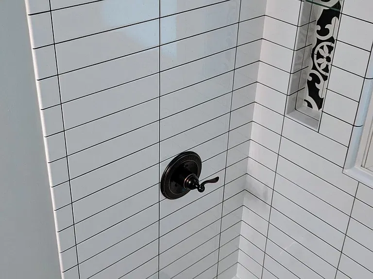 Tiled shower with new fixtures and built-in niches