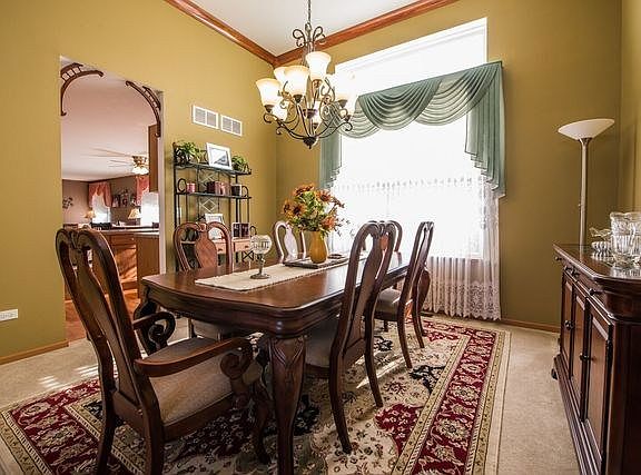 Nice size dining room.  This room is wide enough for a buffet or two. Crown moulding and another larger than life window complet