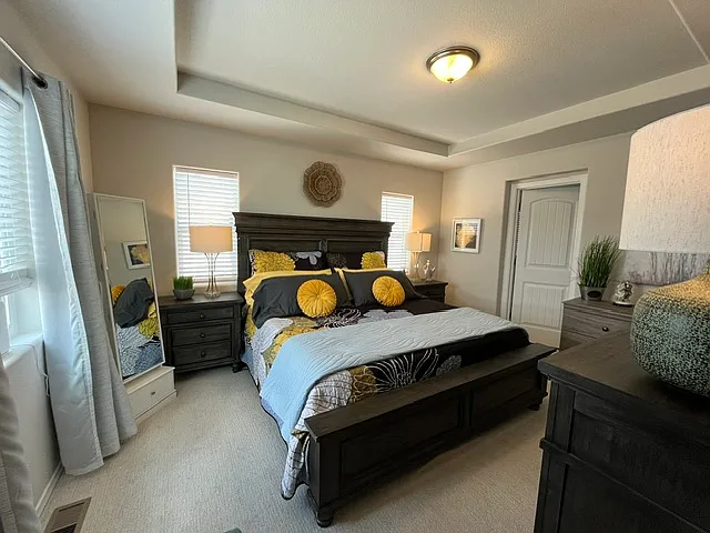 Master bedroom with tray ceiling. King size bed with 2 large night tables and 2 dressers