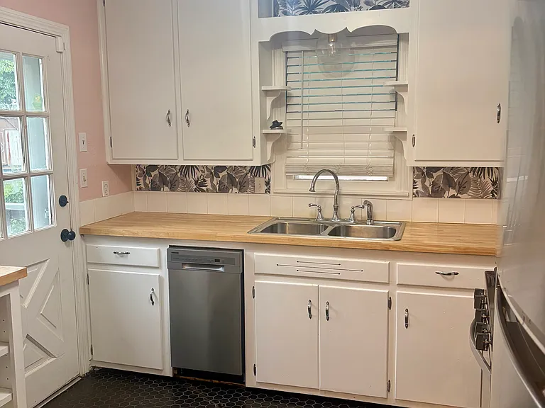 Charming kitchen with new tile and appliances.