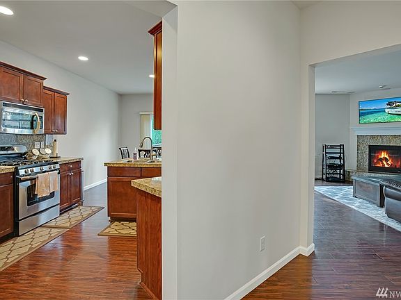 Warm and inviting great room design highlighted by hardwood floors.