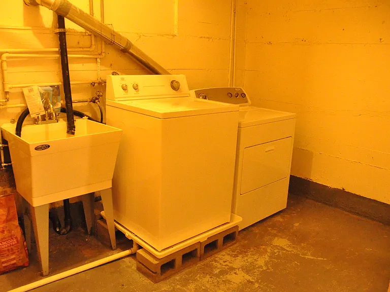 Huge storage space with personal washer dryer and utility sink.