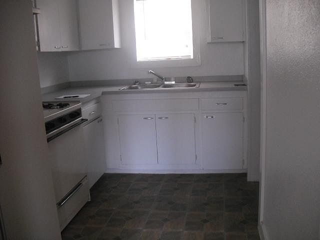 Small kitchen with frig and gas range