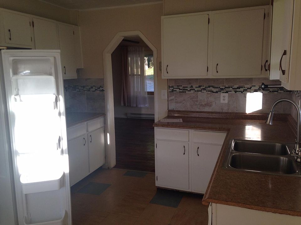 Kitchen with new linoleum flooring and new countertops.