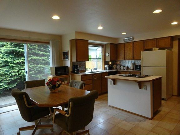 Spacious kitchen and eating area overlook the pretty yard. Garden window floods the area with naturel light. Floors are indestructible, Pergo laminate, panty, housekeeping desk, fully appliance including downdraft range.