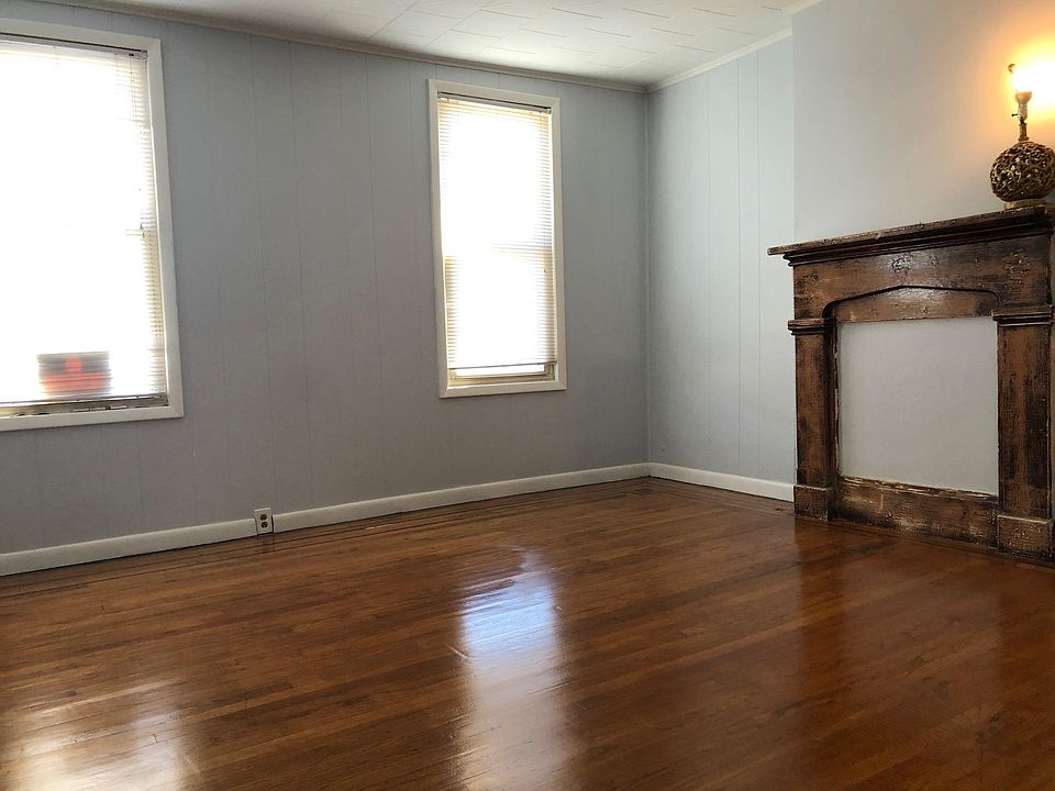 Sunny spacious Living Room with decorative fireplace.