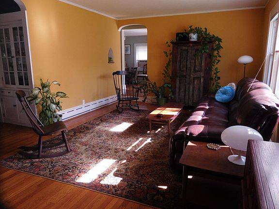 Open design living room now has sectional sofa and 50 inch flat screen TV.