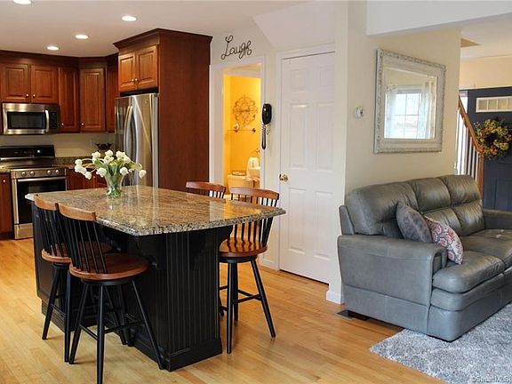 Open floor plan in kitchen and family room with hardwood floors throughout first floor.