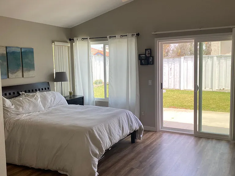 Master bedroom, sliding door leading to backyard