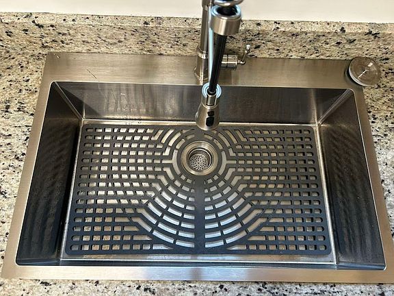 Brand new stainless steel kitchen sink with modern faucet