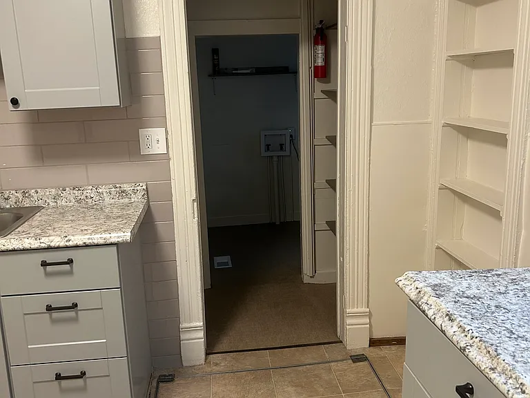 Kitchen into hallway and laundry room on right and bathroom on left