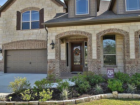 3 car side by side garage, bricked front entrance and key-less entry.