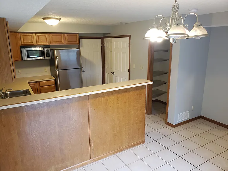 Kitchen view from dining room vantage point, includes pantry