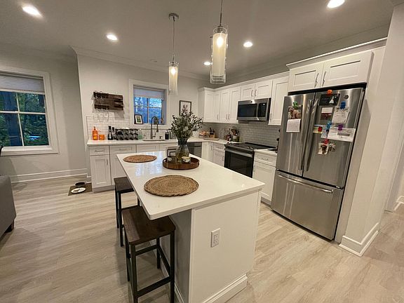 Beautiful bright kitchen area featuring Stainless Steel Appliances & Quartz_s countertops