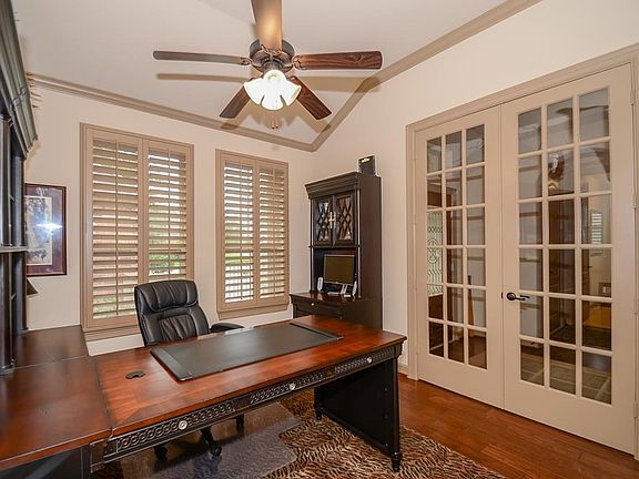 The study is in the front capturing the sunlight or blocking it out with the custom plantation shutters.