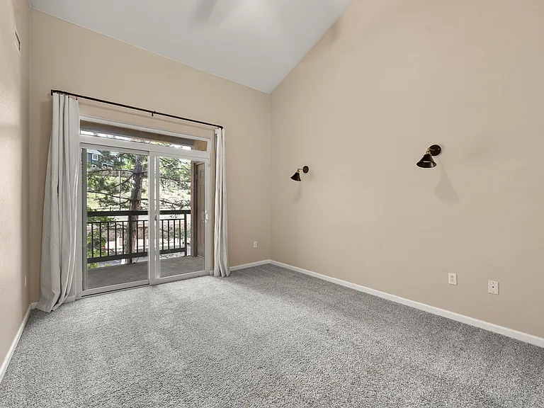 Spacious Primary Bedroom: Vaulted ceilings, private balcony (with storage), walk-in closet, en-suite bath adjoins.