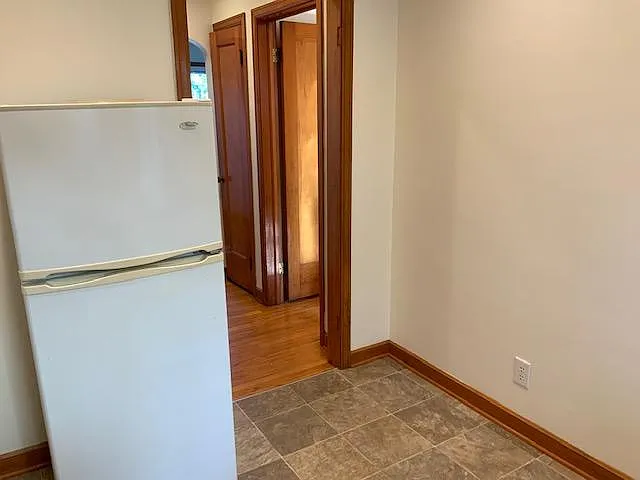 Large refrigerator looking toward hallyway