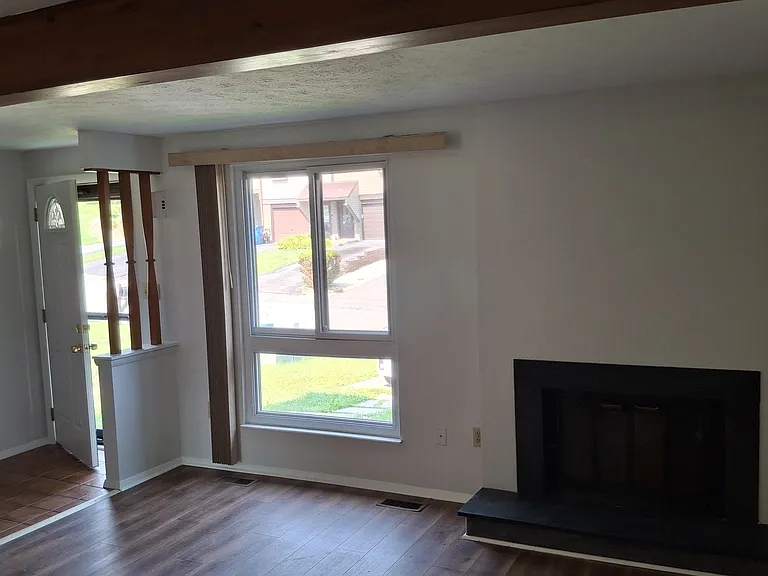 Spacious First floor Living Room with wood-burning fireplace.