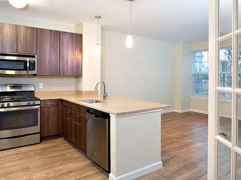 Classic Kitchen with chocolate pecan cabinetry, tile backsplash, laminate countertops, hard surface flooring, and stainless steel appliances