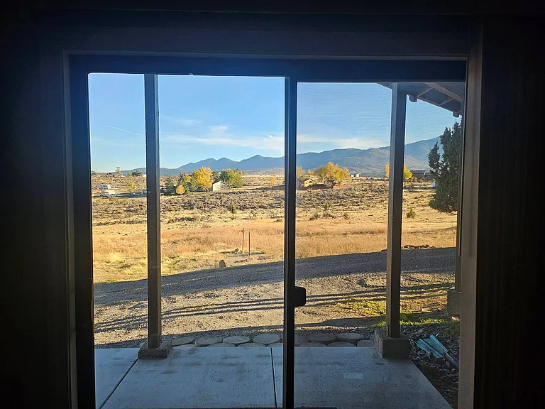 View of property from entry slider onto patio