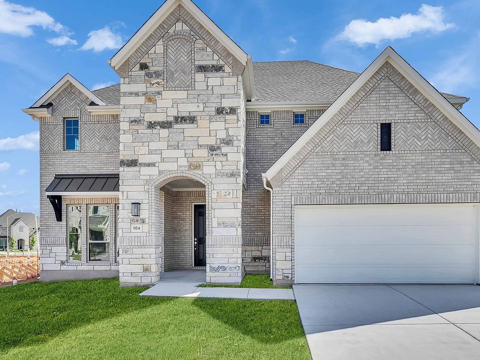 Exquisite stone facade, arched entry, and lush landscaping in Hawkes Landing create unparalleled ele
