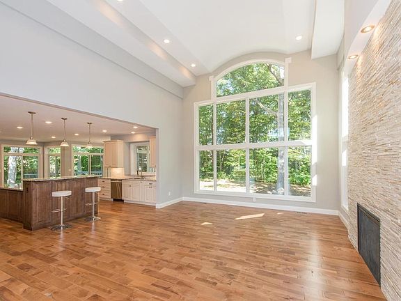 Wooded views abound from the kitchen. Honey Maple hardwood floors shine and the fireplace warms your heart.