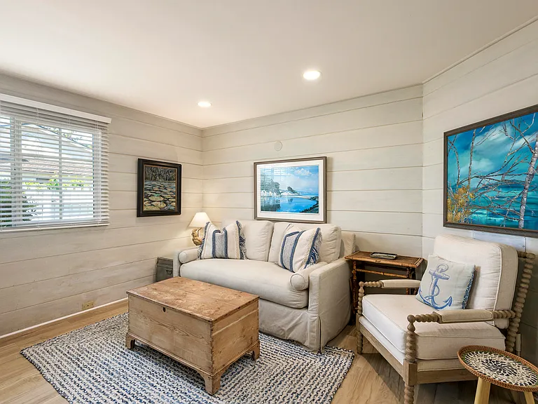The tv den has a flat screen tv (not shown in corner) and a sleeper sofa with half bath.