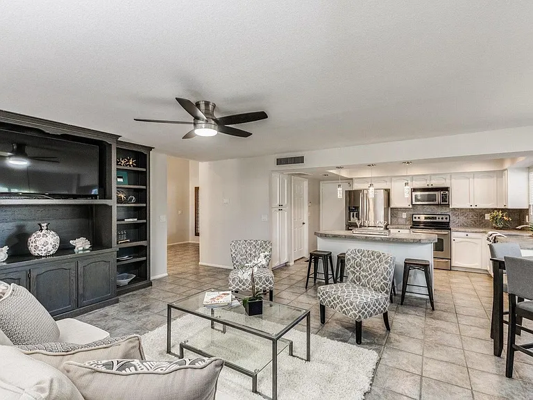 Kitchen opens to Family Room with eat in dining table, island that seats 4-6 easily, big family room with tv and french doors to pool and patio!