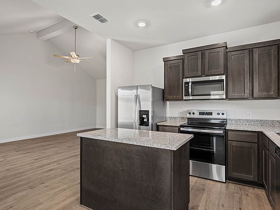 The kitchen has beautiful wood cabinetry.