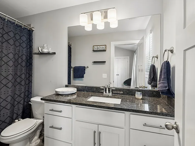 Private primary bedroom with ensuite bath and abundant natural light.
