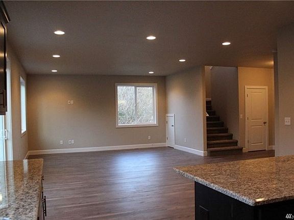 Great room concept with beautiful wide plank laminate wood look flooring.