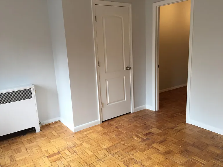 Partial view of Bedroom 2 with built-in closet & door to living room