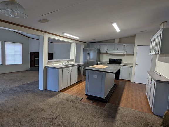 Left is Large Living Room, Middle large Kitchen Area and on right is a Family Room with Dining Area very front of picture