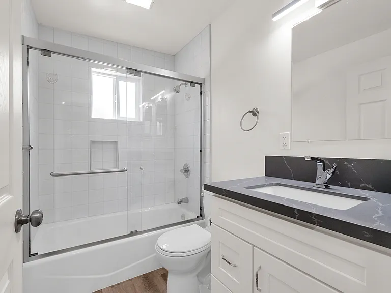 Bathroom with full size tub and glass shower doors